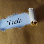 Jim Crow Accusations EXPOSED—Numbers Don’t Lie Ripped paper reveals word truth underneath brown surface