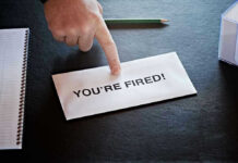 Envelope with YOURE FIRED and pointing finger.