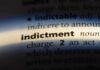 Close-up of a dictionary page showing the definition of 'indictment'