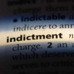 Close-up of a dictionary page showing the definition of 'indictment'