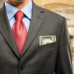 Mandelson’s Epstein Cash Exposed Man in a suit with a red tie and money peeking from his pocket