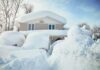 A house surrounded by deep snow drifts after a heavy snowfall