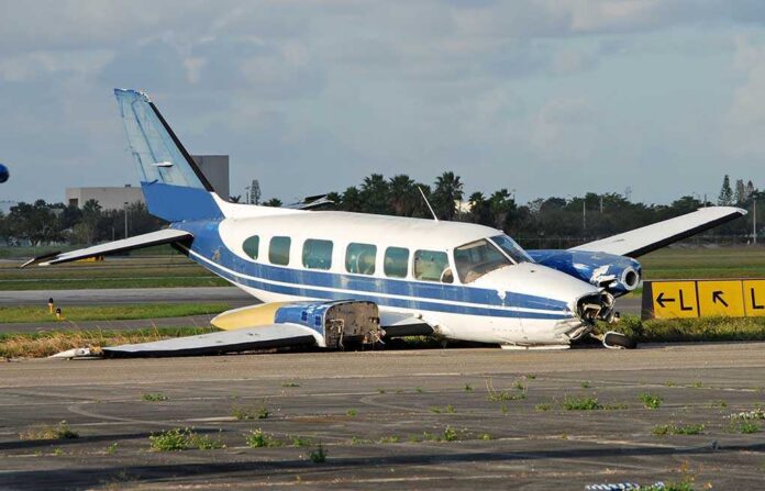 shutterstock_2445734.jpg Damaged blue and white small airplane on an airport runway