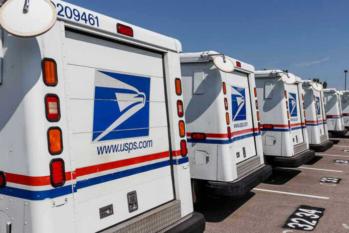 Row of USPS mail delivery trucks parked.