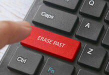 Finger pressing ERASE PAST key on keyboard.