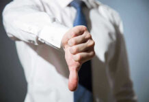 Person giving a thumbs down gesture.