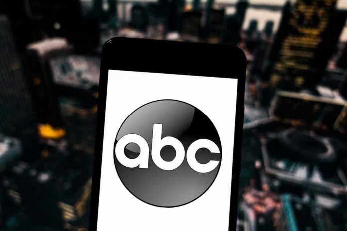 shutterstock_1351717706 (1).jpg A smartphone displaying the ABC logo against a blurred urban background