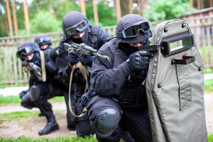 A tactical team in black gear preparing for an operation