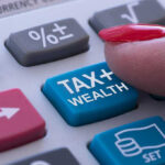 Socialist Mayor TAUNTS High Earners With Tax Blitz Finger pressing calculator tax and wealth button
