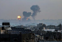 Massive U.S. Air Raid Hits Kharg Flames and smoke billowing over a cityscape.