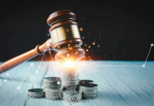 Gavel, coins, and tax icons on a table.