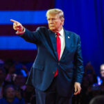 Shock Move: Trump Escalates Strait of Hormuz Crisis Person in suit pointing during a public event.