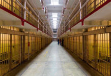Federal Agents CRUSH $50M BLATANT Scam Long hallway with prison cells on both sides.