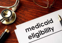 Stethoscope pen document about Medicaid eligibility on table