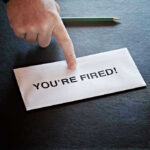 AI Godfather’s Brutal Warning–THESE Jobs Are GONE Envelope with YOURE FIRED and pointing finger.