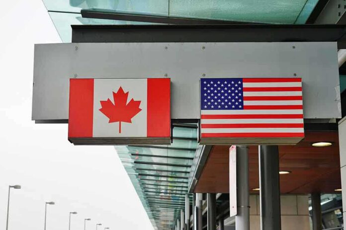 Canadian and American flags displayed at a border crossing