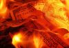 Burning U.S. dollar bills surrounded by flames