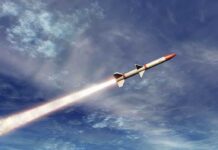 A missile ascending into the sky with a trail of smoke