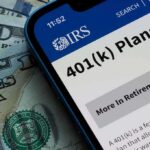 Tax Evaders Beware: DOJ’s Secret Weapon Unveiled Mobile phone displaying IRS information about 401(k) plans on a background of cash