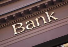 Close-up of a bank sign with gold lettering