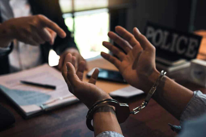 Person handcuffed in discussion with another person
