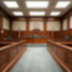 Grammy Winner’s $20M Scandal — HEADING to PRISON Empty courthouse courtroom with wooden benches and chairs.