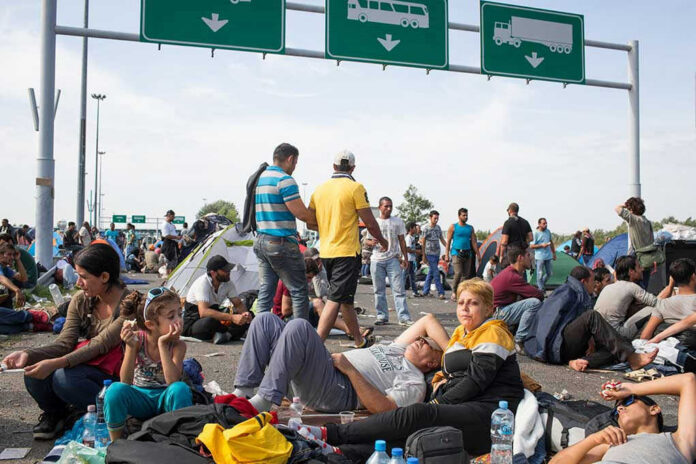 325232072 People sitting and resting on a highway.