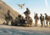 Shocking Drone Attack Topples PM! Soldiers operating a drone in a desert environment.