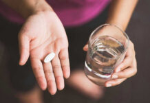 NO CONTEST: Doctor’s SINISTER Plot INVEILED Person holding pill and glass of water