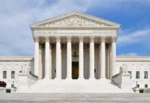 Mayor Busted as China’s Hidden Agent Front view of the Supreme Court building with large columns and steps under a blue sky