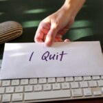 Utah’s Top Judge SUDDENLY Quits — WHAT’S SHE HIDING? A hand placing an envelope labeled 'I Quit' on a keyboard