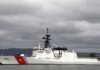 Cocaine Boat Disabled—Legal Line Crossed? A U.S. Coast Guard ship docked under cloudy skies