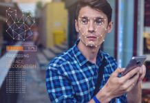 Disneyland SCANDAL: Secret Face Scans EXPOSED! Young man using a smartphone with face recognition overlay
