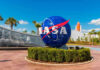 $264M NASA Crash: Upside-Down Sensors? NASA logo sculpture with spaceship and palm trees.