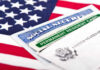 The DHS Testimony That Exposes a Massive Government Failure Social Security card and green card on flag.