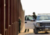 Senate Just Locked In $70 Billion for ICE and Border Patrol — 3 Years Border patrol agents near a tall metal fence.