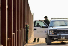Senate Just Locked In $70 Billion for ICE and Border Patrol — 3 Years Border patrol agents near a tall metal fence.