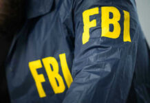 FBI’s Ghost: Why This Boss Stays Free FBI jacket with yellow letters.