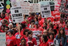 Teachers and supporters protesting for fair contracts in red shirts