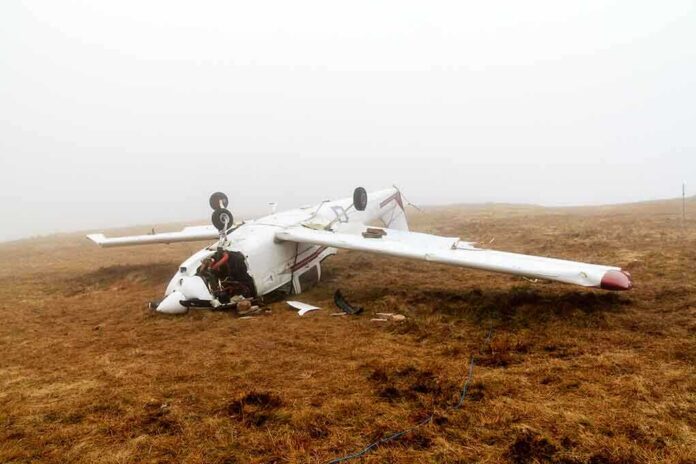 shutterstock_128891288-1 Crashed airplane lying on its side in a foggy field