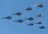 A formation of military jet fighters flying in a clear blue sky
