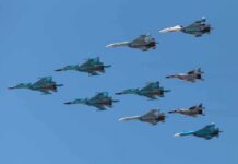 Shock Vow: German Jets Ready Now A formation of military jet fighters flying in a clear blue sky