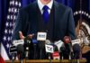 White House Meltdown Over Alleged Tapes A speaker at a press conference with multiple microphones in front of them