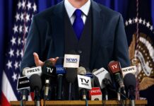 White House Meltdown Over Alleged Tapes A speaker at a press conference with multiple microphones in front of them