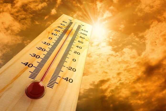 A thermometer displaying temperature against a sunset sky