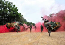 Stalemate Trap Tightens On Kremlin Soldiers running from armored vehicles with red smoke.