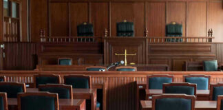 Empty courtroom with wooden furnishings and judges bench.