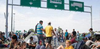 People sitting and resting on a highway.