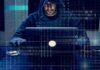 The Phone Scam Network Facing a Federal Sweep Person in hoodie using a laptop with binary code overlay