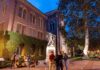 bronze athlete statue on campus at dusk